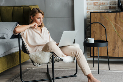 A woman reading on a laptop